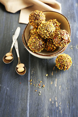 Tasty homemade pistachio candies on wooden table