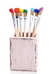 Brushes with colorful paints, isolated on white