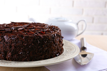 Tasty chocolate cake with teapot