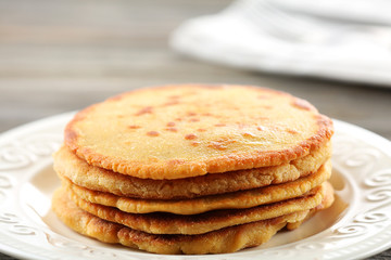 Tasty fritters on plate on table close up