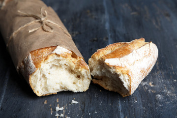 Fresh  baguette on wooden table, close up