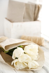 White beautiful tulips on wooden windowsill