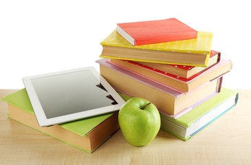 Books, PC tablet and apple on desk, isolated on white