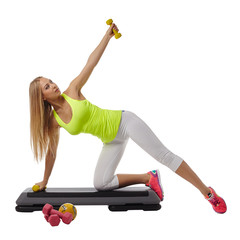 Beautiful blonde doing fitness exercises in studio