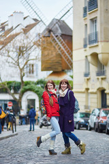 Two cheerful beautiful girls in Paris