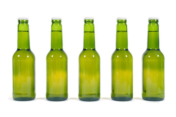 Row or line of green beer bottles isolated on white background photo