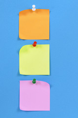 Vertical row or line of post it sticky note pinned to blue background photo