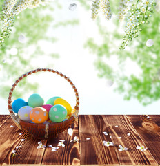 Easter eggs in the nest on rustic wooden table