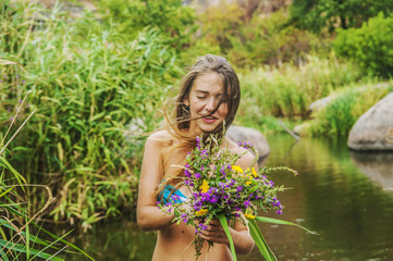 young caucasian female with flowers near the river
