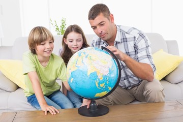 Family exploring globe