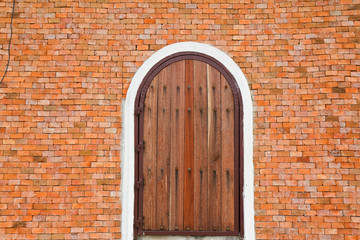 Wooden door on a brick wall.