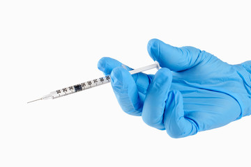Hand in glove with syringe on white background. Injections.