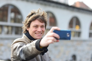 Student / tourist taking self portrait in the europe street