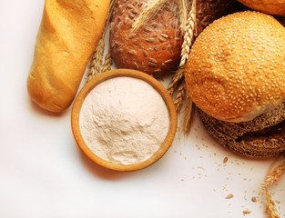 Fresh bread with wheat, sesame, sunflower seeds and wooden bowl
