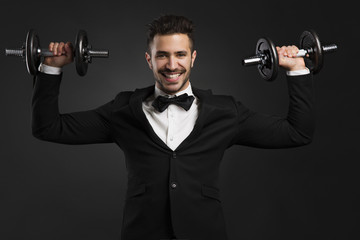 Fototapeta na wymiar Young man lifting weights