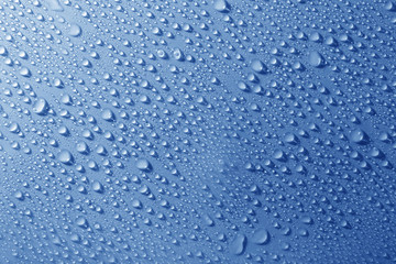 Water drops on glass on light background