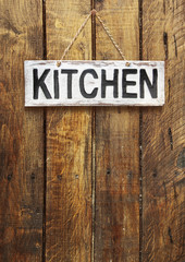 signboard "kitchen" on a wooden background