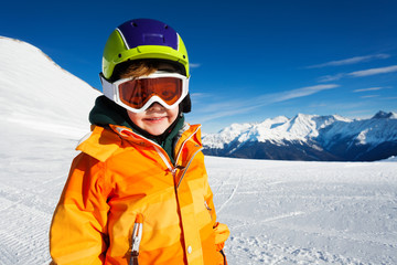 Fototapeta na wymiar Close-up view of boy wearing ski mask on ski-track