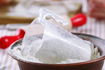 Flour in bowl on table close up