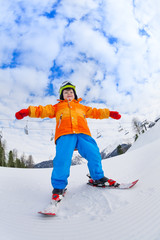 Fototapeta na wymiar View from below of boy in ski mask skiing