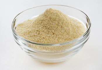 Glass bowl with cornmeal isolated on white