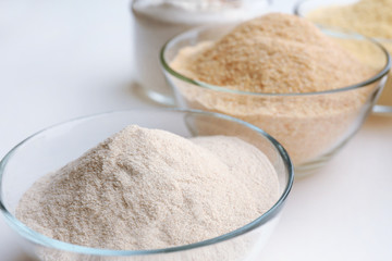 Different types of flour in bowls close up