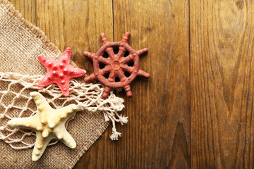 Sea stars on sackcloth on wooden background