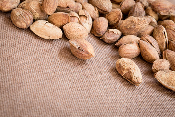 Roasted almonds in shell on wooden table