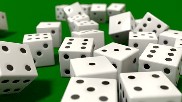 Dice rolling white slow motion closeup DOF on green felt tableto