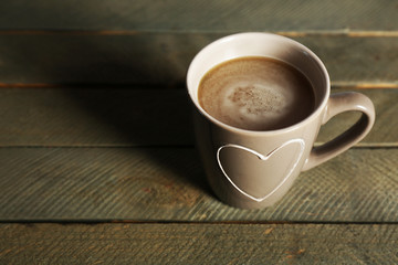 Cup of cocoa on rustic wooden planks background