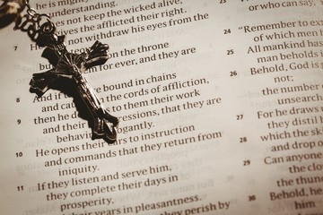 Open bible and silver crucifix