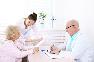 Fototapeta premium Happy doctors and patient in hospital clinic