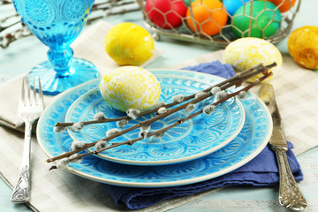 Easter table setting on color wooden background