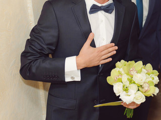 Groom with hand on Chest