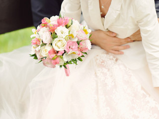 Obraz na płótnie Canvas Groom Holding Bride with Bouquet