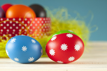 Colored Easter eggs on the grass and blue sky background