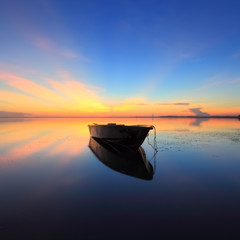 lonely boat during sunrise