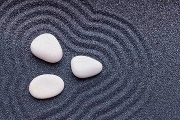 Fototapeta na wymiar Zen garden with a silk white stones with wave patterns in the sa