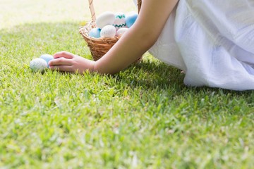 Little girl collecting easter eggs