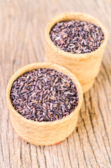 raw brown sticky rice on bamboo basket
