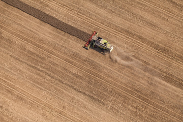 aerial view of combine on harvest field
