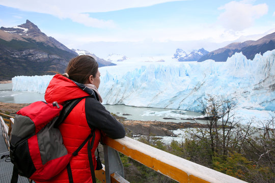 Tourist standing on footbridge in front of Perito Moreno Glacier