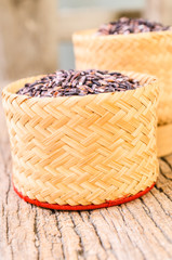 raw brown sticky rice on bamboo basket