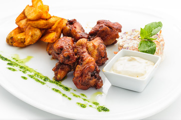Deep fried chicken with baked potato and tartar sauce, on white