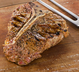 Grilled BBQ T-Bone Steak on a wooden table