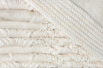White knitted blanket folded in layers