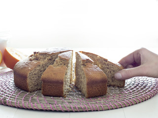 Human hand taking a piece of cake isolated on white