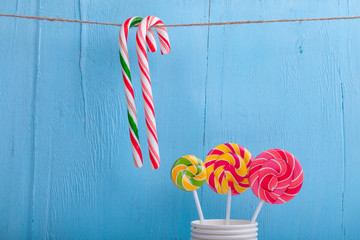 cups and lollipop on the blue wooden background