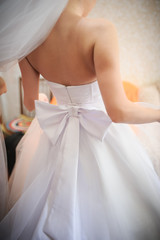 bride getting dressed on her best day ever