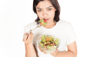 Pretty girl eating fresh vegetable salad